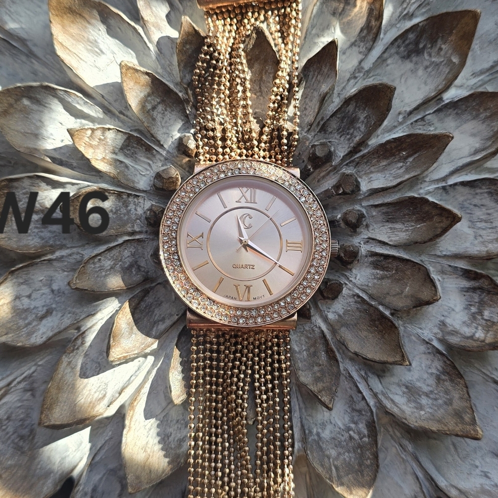 Rose gold-tone women's watch featuring a diamond-like bezel